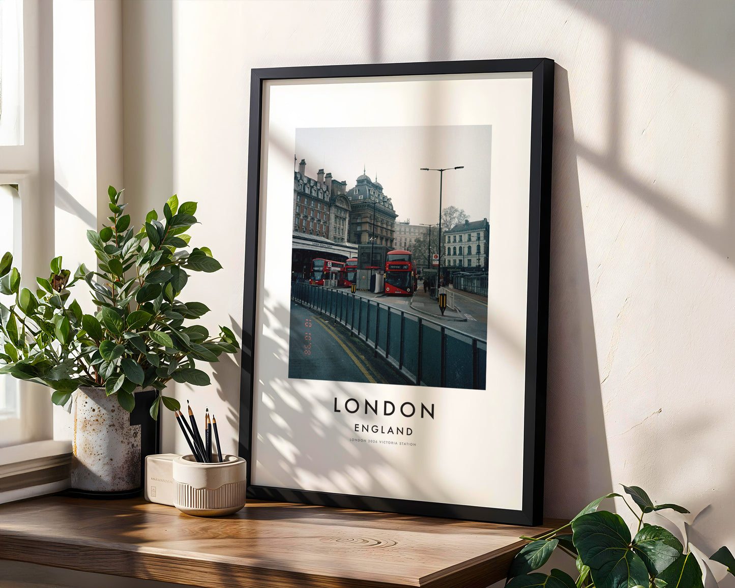Victoria Station Red Buses Classical Building - London analogue photography poster print in modern room setting