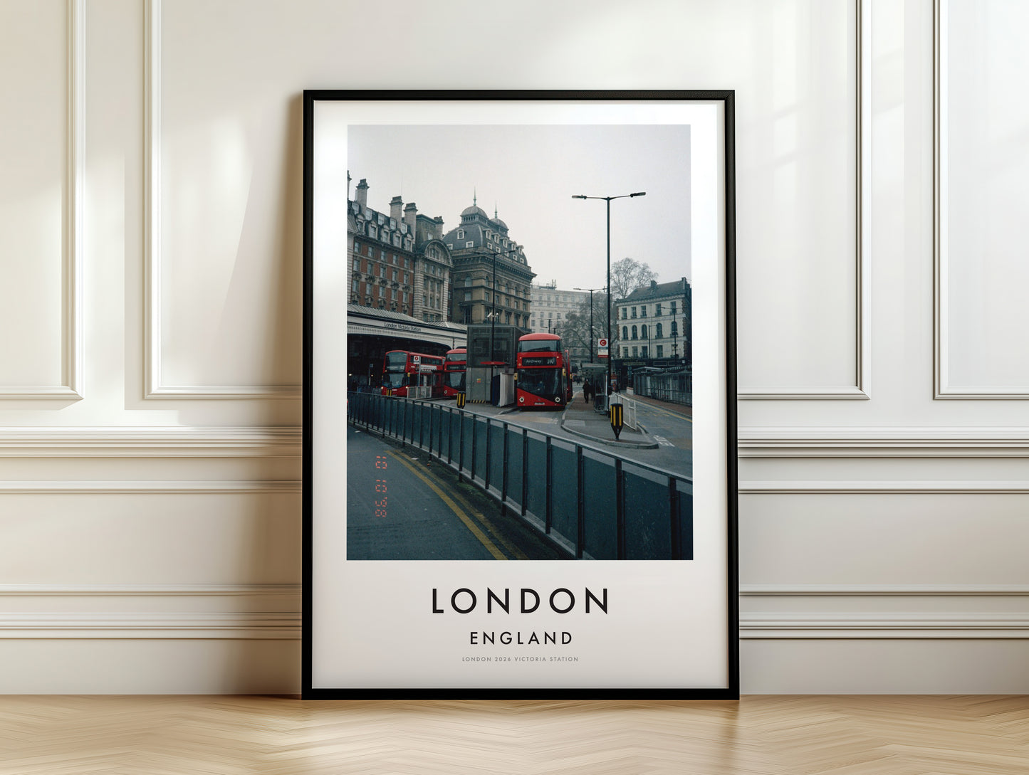Victoria Station Red Buses Classical Building - London analogue photography poster print on white panelled wall