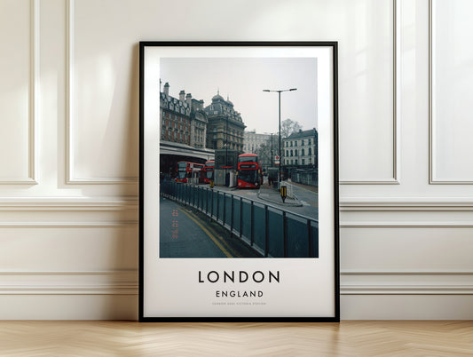 Victoria Station Red Buses Classical Building - London analogue photography poster print on white panelled wall